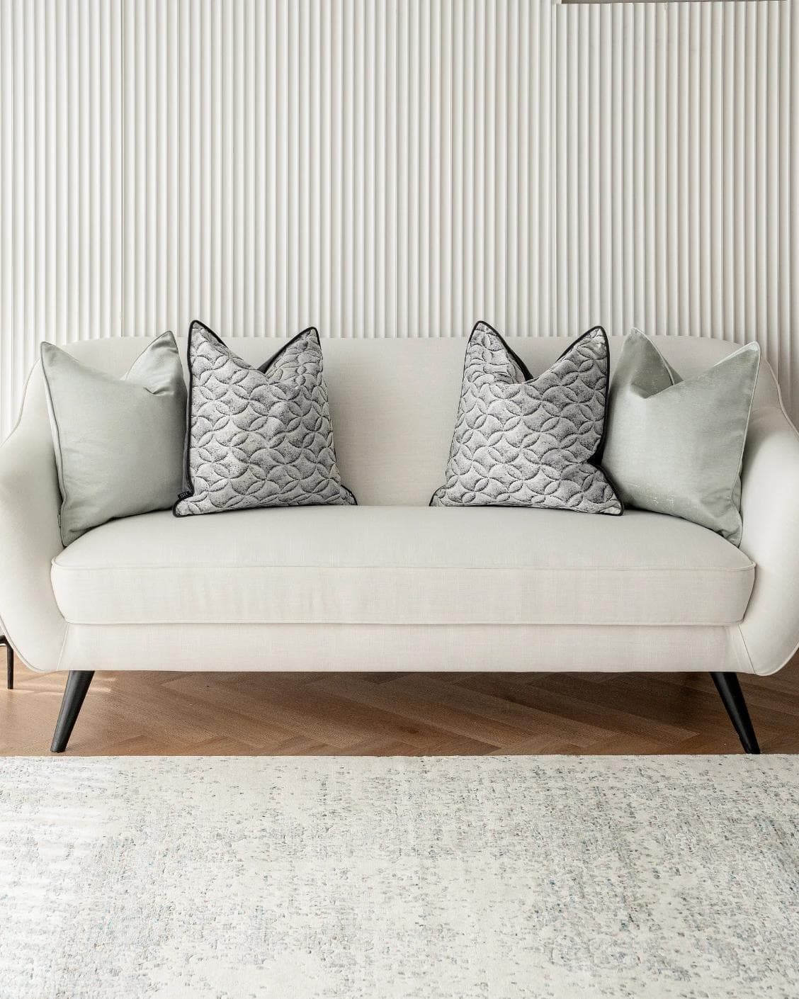 Carissa Bundle cushion in white, black, green and silver, shown in a lifestyle front view as image 4