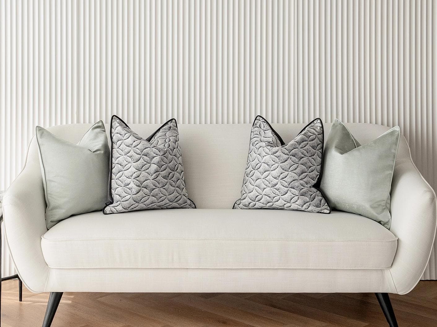 Carissa Bundle cushion in white, black, green and silver, shown in a lifestyle front view as image 4