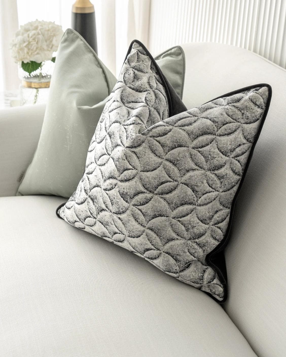 Carissa Bundle cushion in white, black, green and silver, shown in a lifestyle right view as image 6