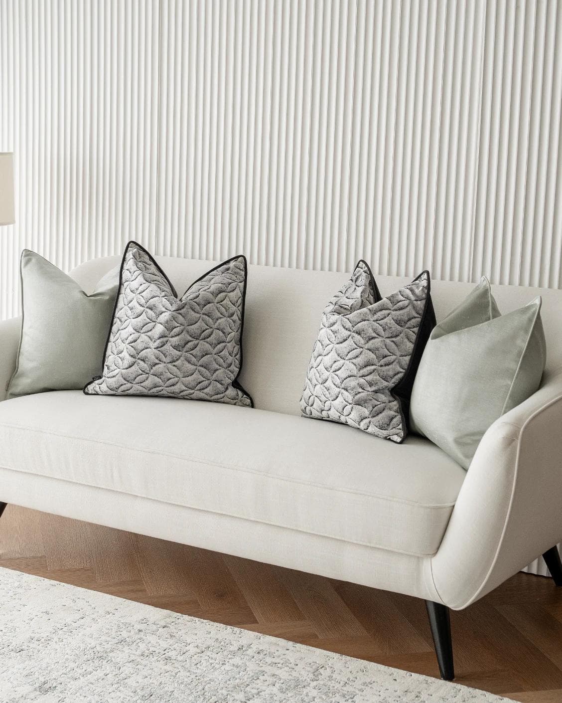 Carissa Bundle cushion in white, black, green and silver, shown in a lifestyle right view as image 2
