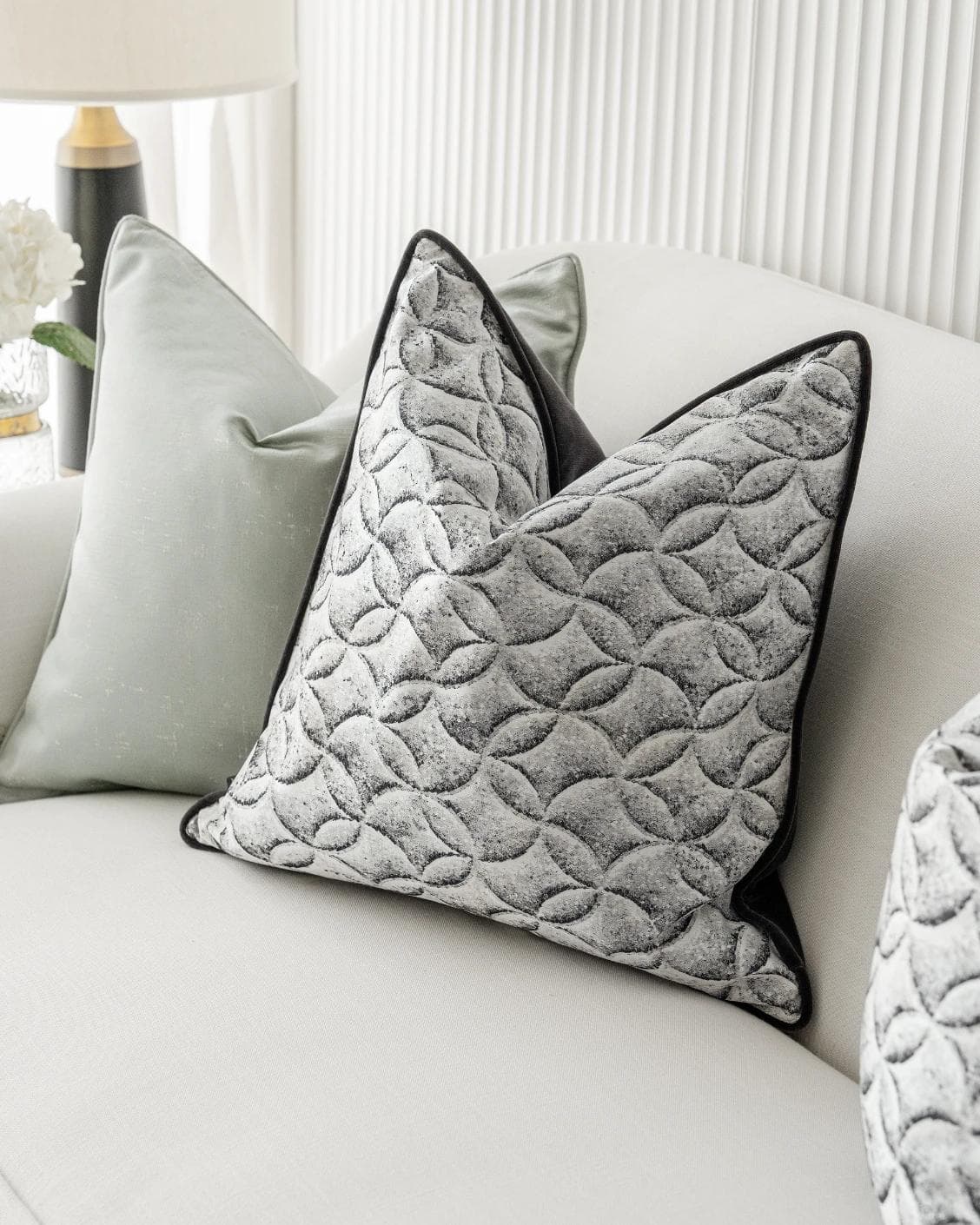 Carissa Bundle cushion in white, black, green and silver, shown in a lifestyle right view as image 5