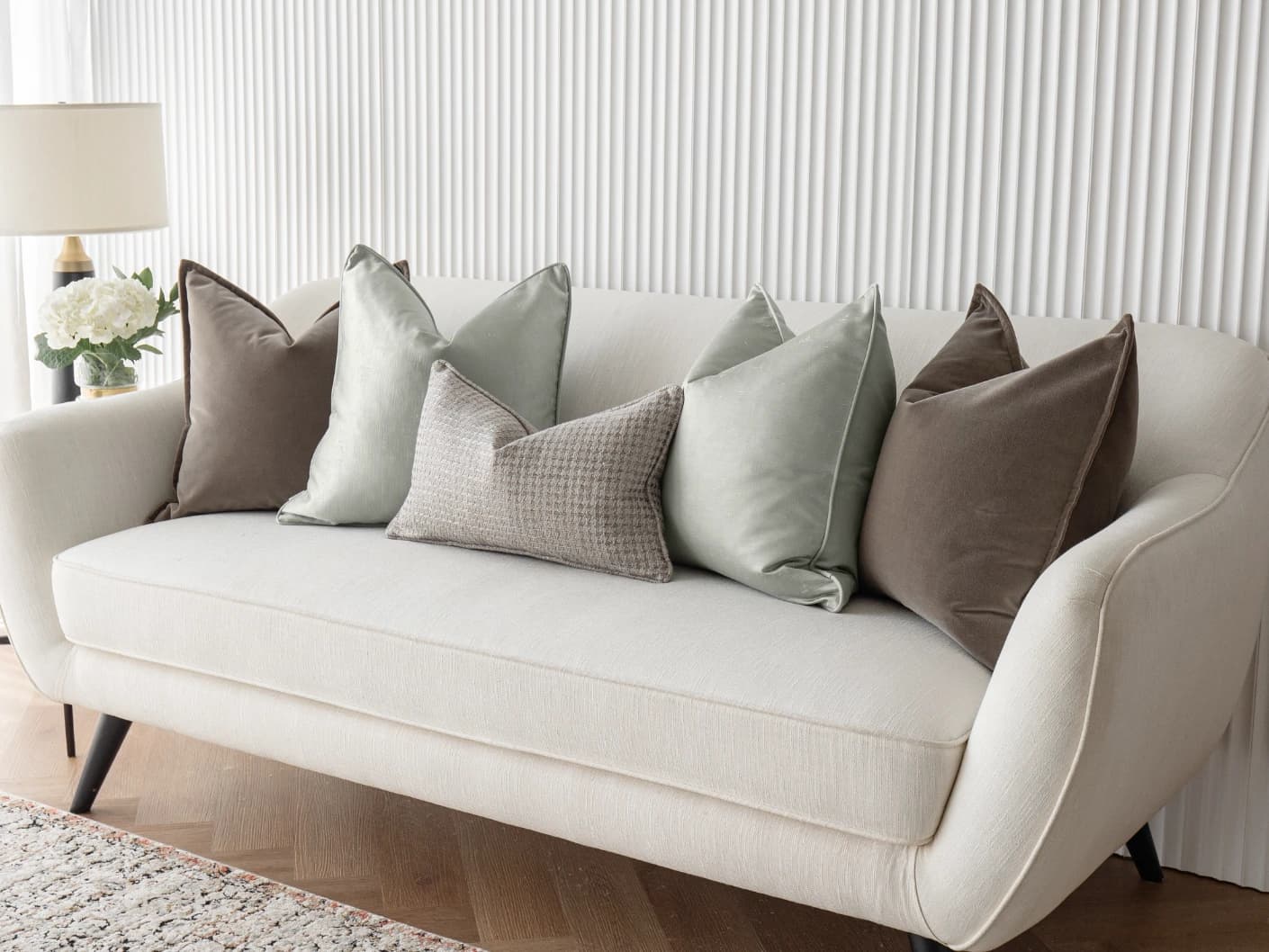 Amaris Bundle bundle cushions in brown, green and silver, shown in a lifestyle front view