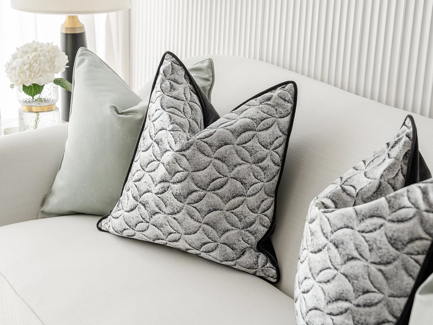Carissa Bundle bundle cushions in white, black, green and silver, shown in a lifestyle front view