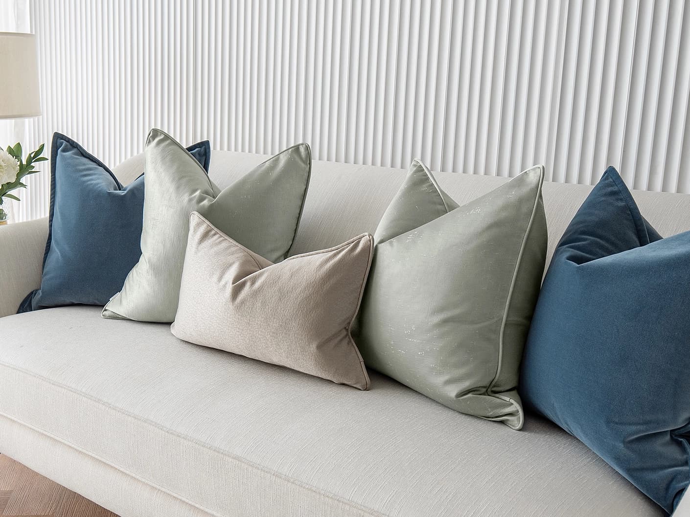 Johnston Bundle bundle cushions in gold, blue, beige, green and silver, shown in a lifestyle front view
