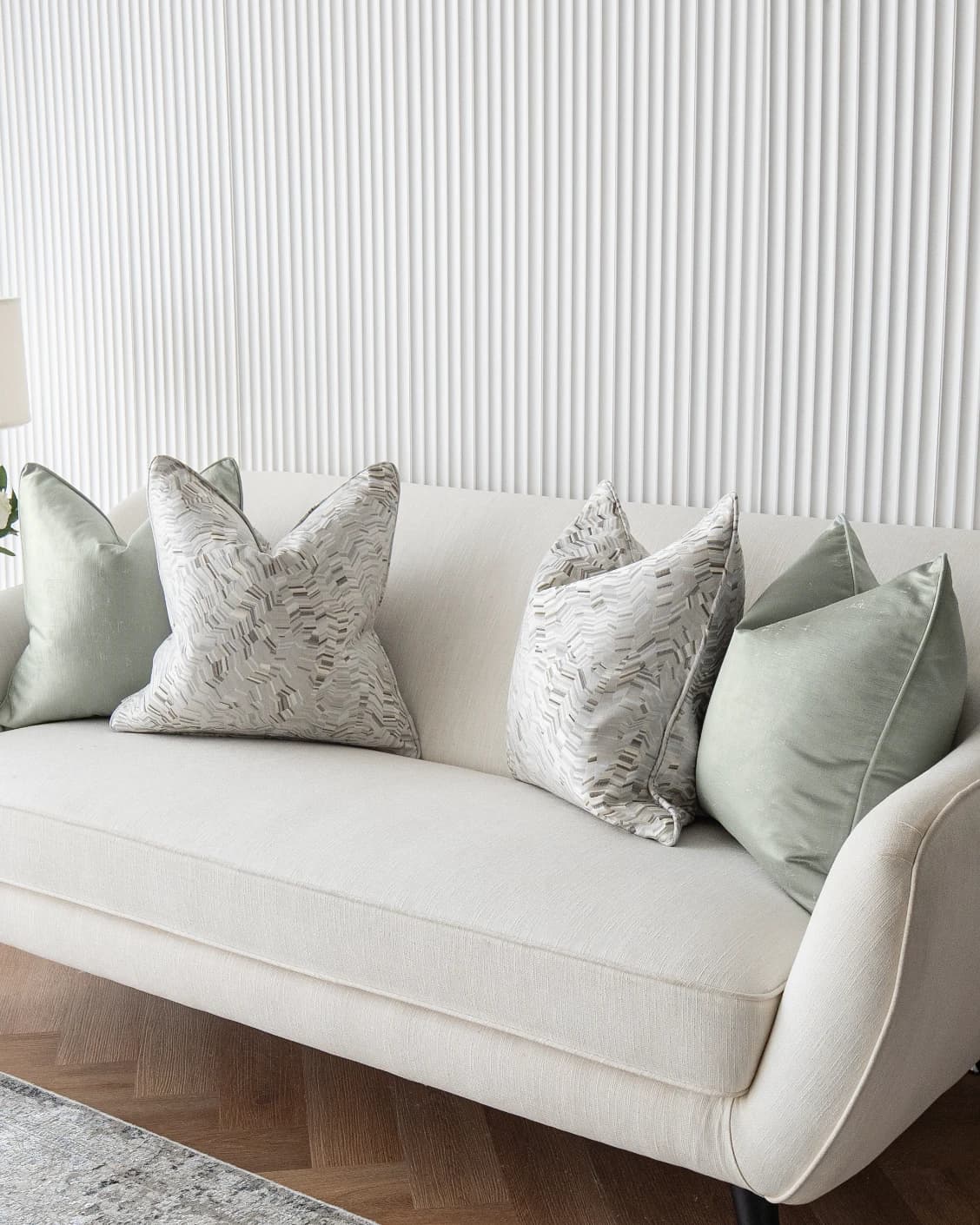 Marjorie Bundle cushion in silver, grey and green, shown in a lifestyle front view as image 2