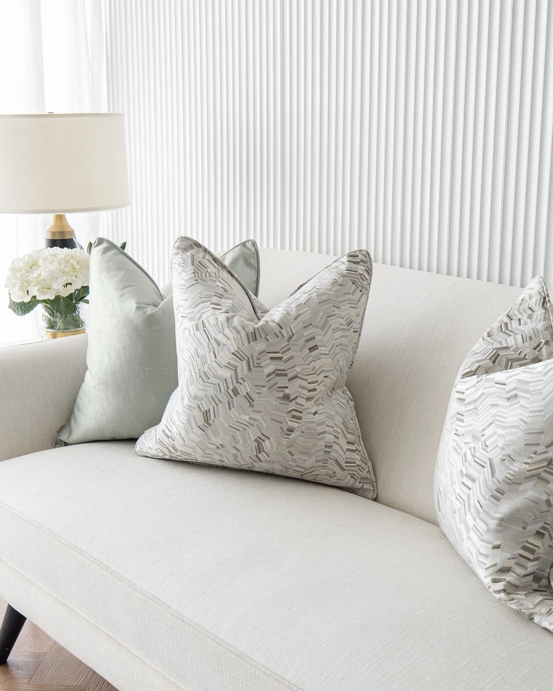 Marjorie Bundle cushion in silver, grey and green, shown in a lifestyle front view as image 5