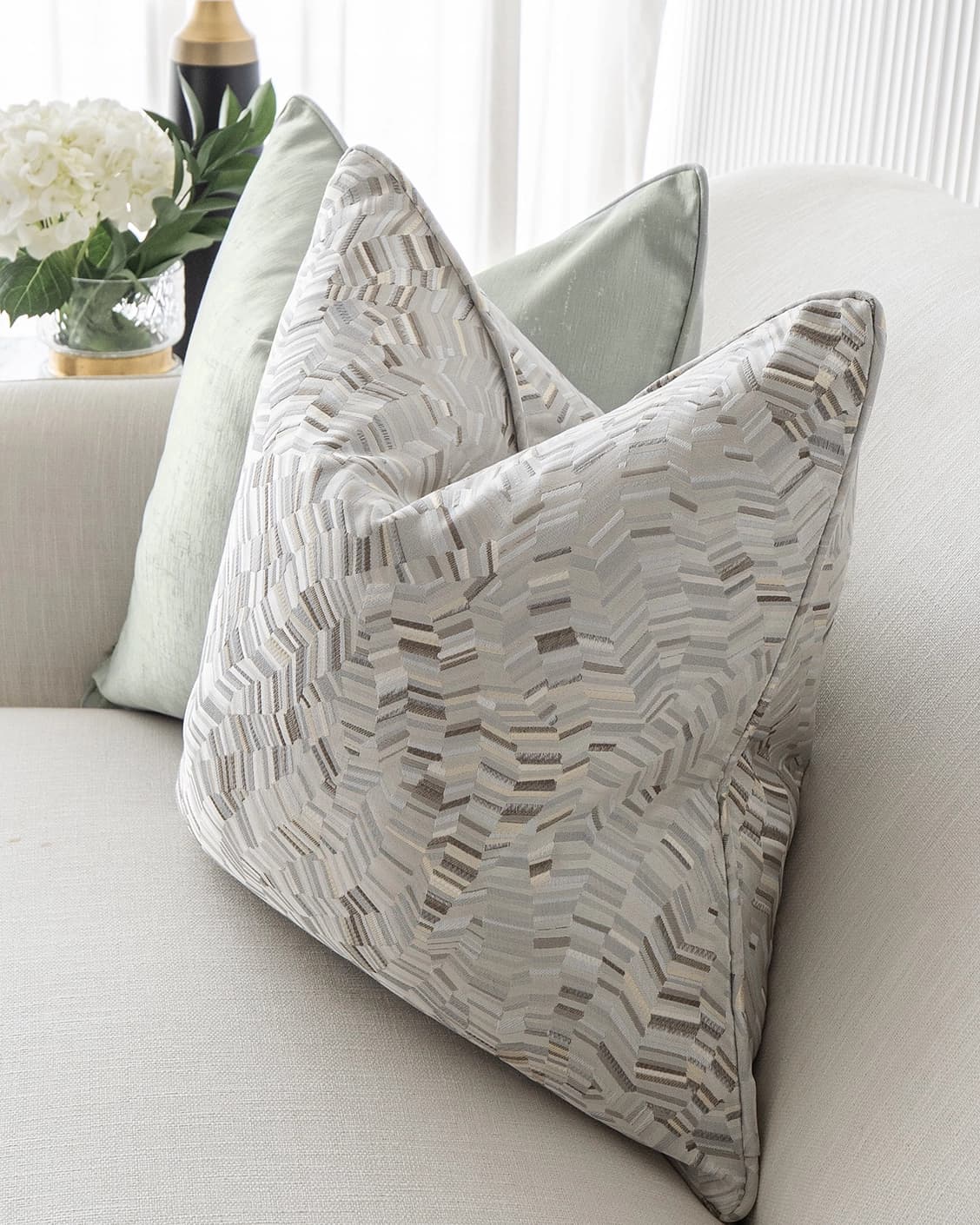 Marjorie Bundle cushion in silver, grey and green, shown in a lifestyle front view as image 6