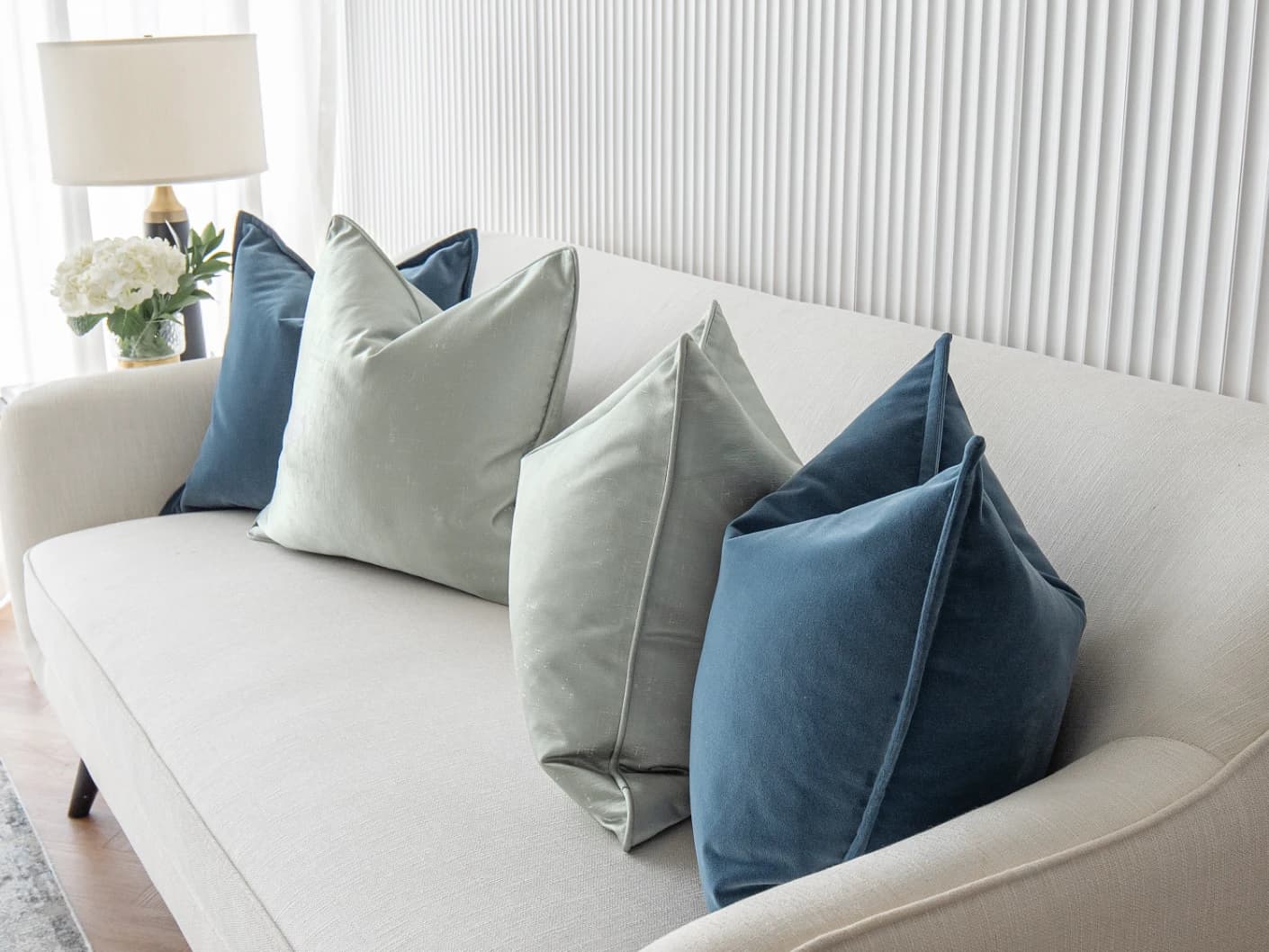 Vladimir Bundle bundle cushions in blue, green and silver, shown in a lifestyle front view