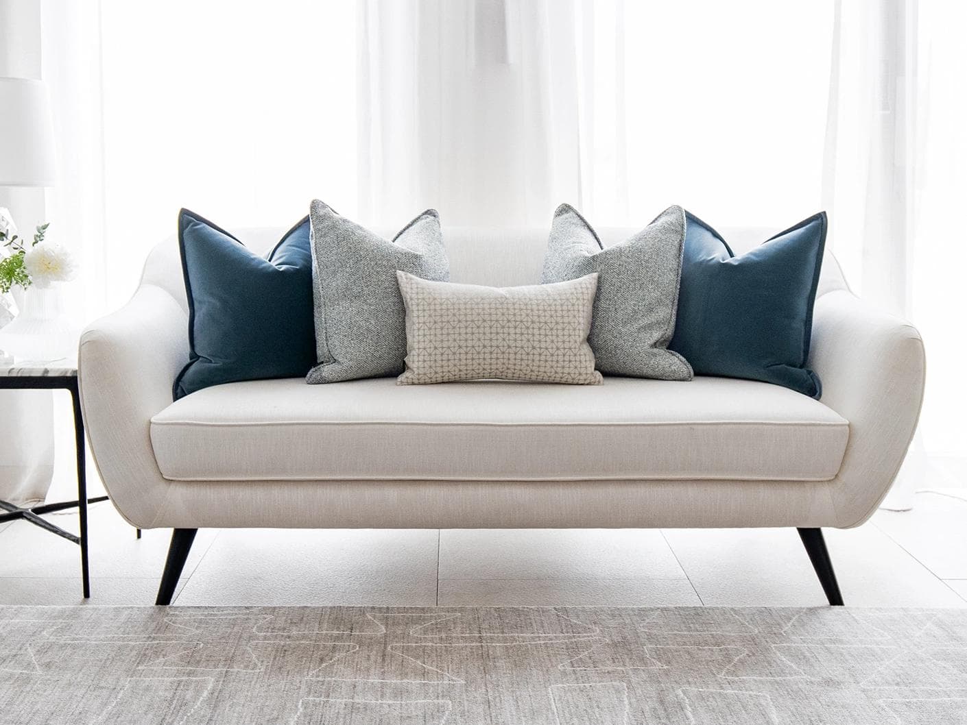 Samuel Bundle cushion in blue, silver and white, shown in a lifestyle front view as image 4