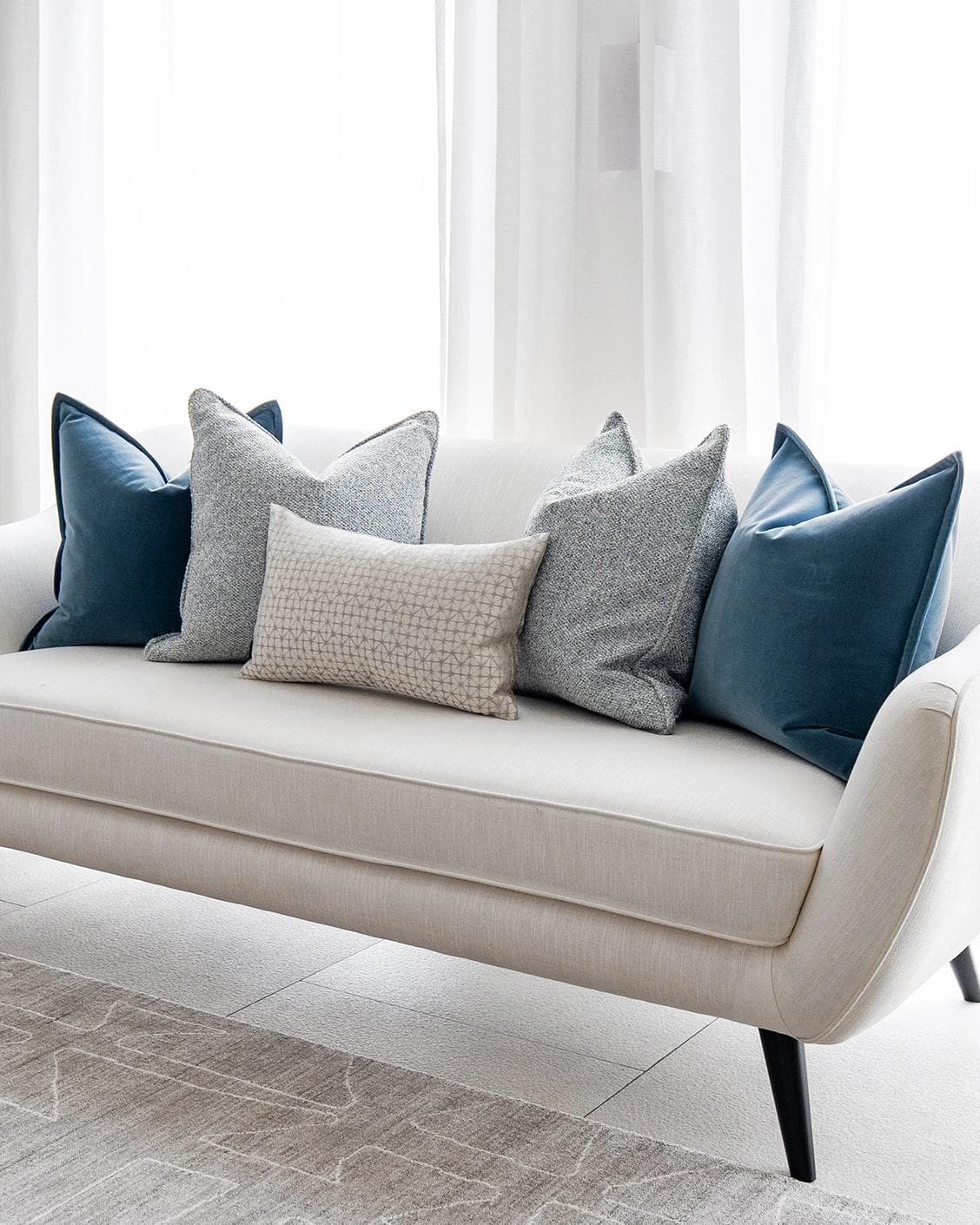 Samuel Bundle cushion in blue, silver and white, shown in a lifestyle right view as image 2