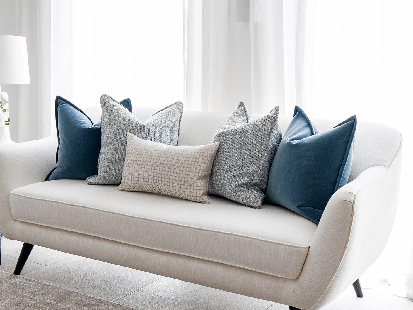 Samuel Bundle cushion in blue, silver and white, shown in a lifestyle right view as image 2