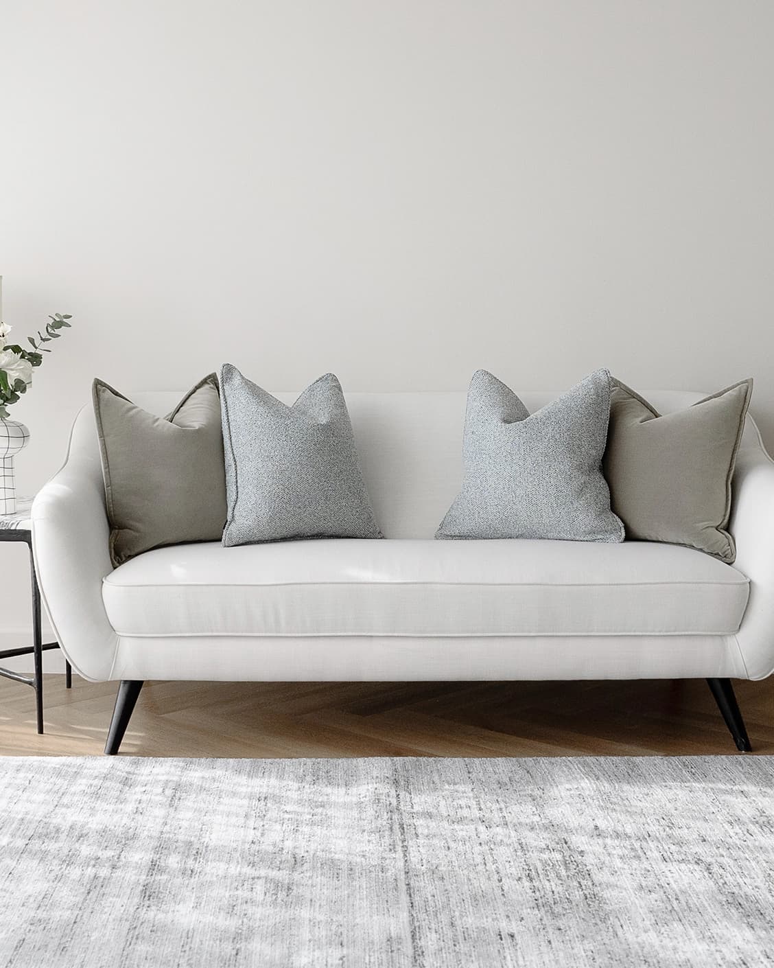 Tom Bundle cushion in grey and blue, shown in a lifestyle front view as image 4