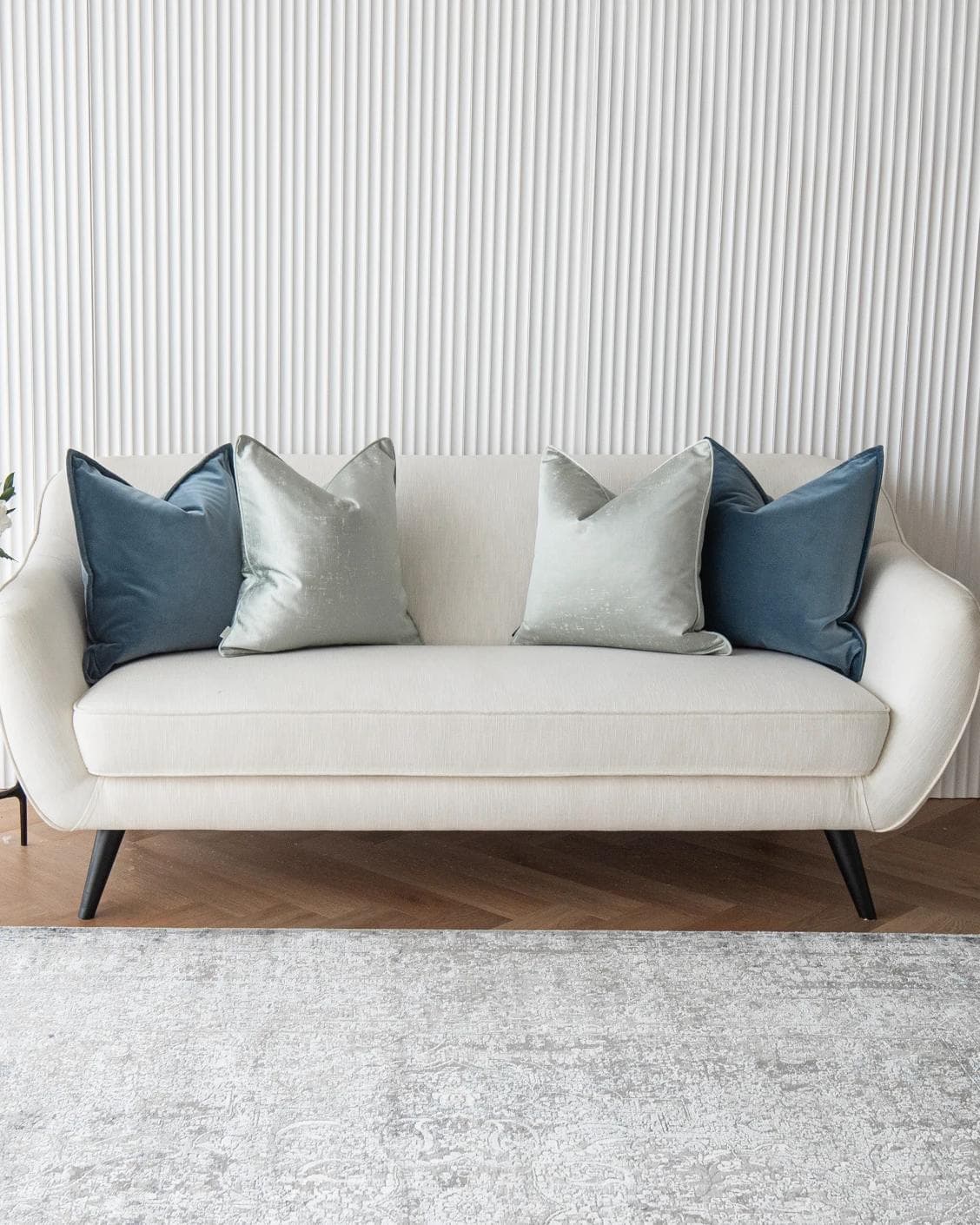 Vladimir Bundle cushion in blue, green and silver, shown in a lifestyle front view as image 2