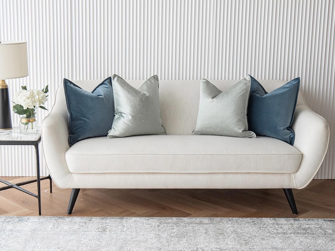 Vladimir Bundle cushion in blue, green and silver, shown in a lifestyle front view as image 2
