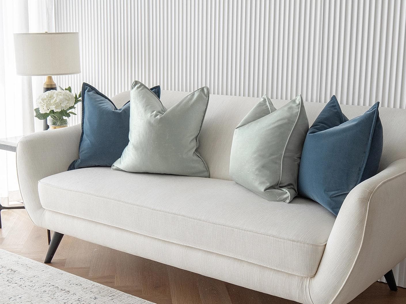 Vladimir Bundle cushion in blue, green and silver, shown in a lifestyle right view as image 4