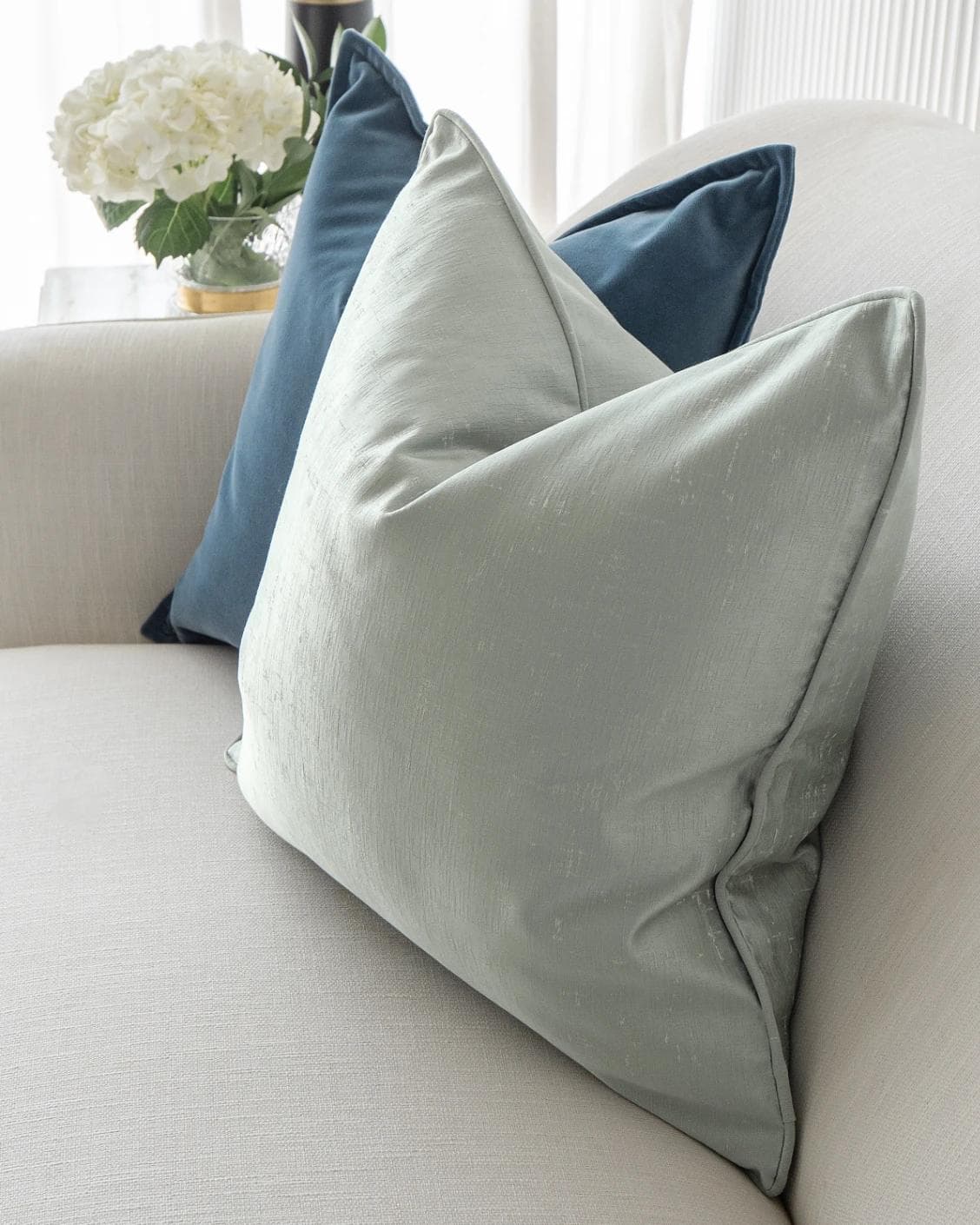 Vladimir Bundle cushion in blue, green and silver, shown in a lifestyle top view as image 6