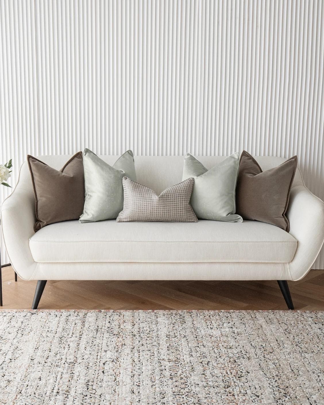 Amaris Bundle cushion in brown, green and silver, shown in a lifestyle front view as image 4