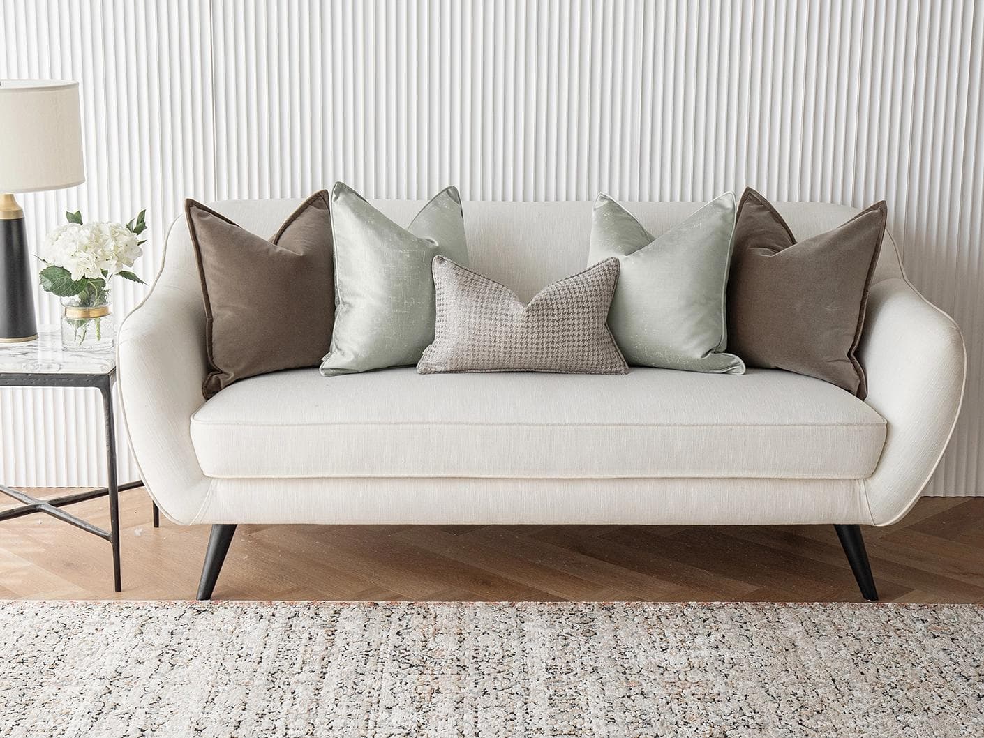 Amaris Bundle cushion in brown, green and silver, shown in a lifestyle front view as image 4