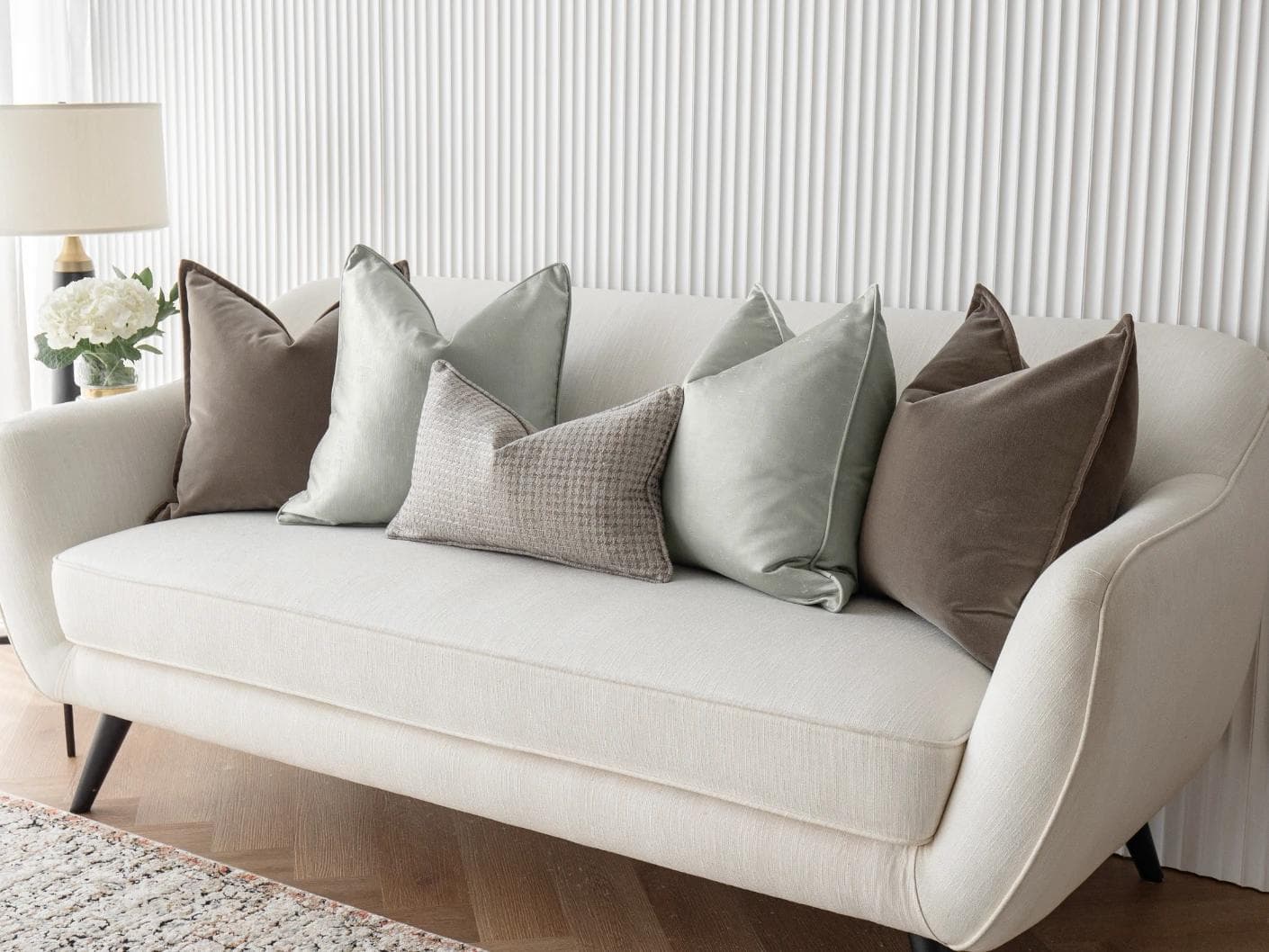 Amaris Bundle cushion in brown, green and silver, shown in a lifestyle right view as image 2