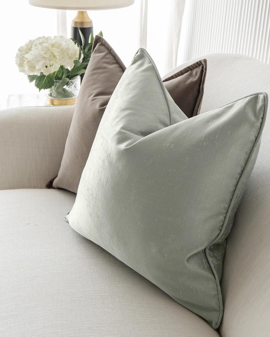 Amaris Bundle cushion in brown, green and silver, shown in a lifestyle right view as image 8