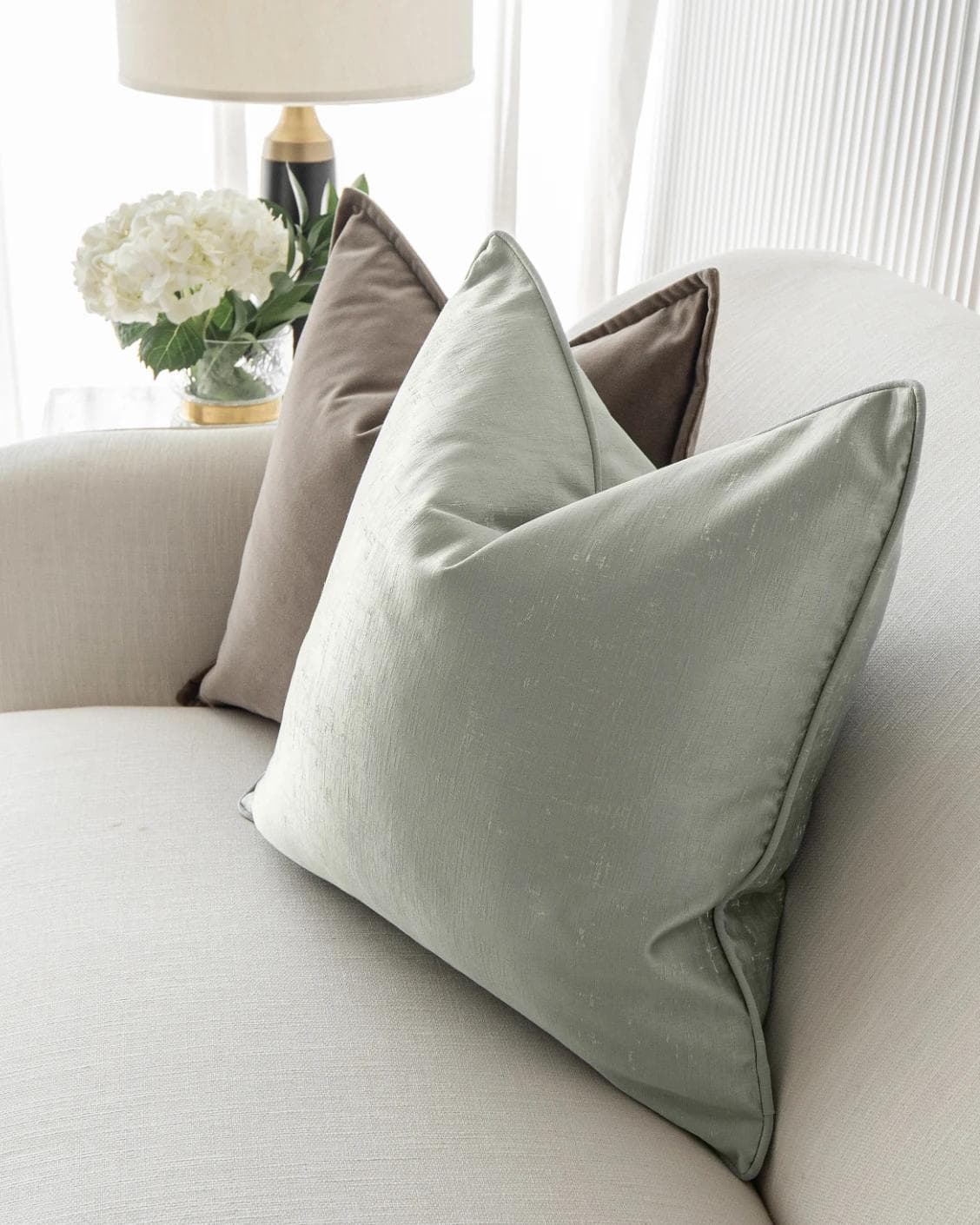 Eliazar Bundle cushion in brown, orange, silver and green, shown in a lifestyle right view as image 6