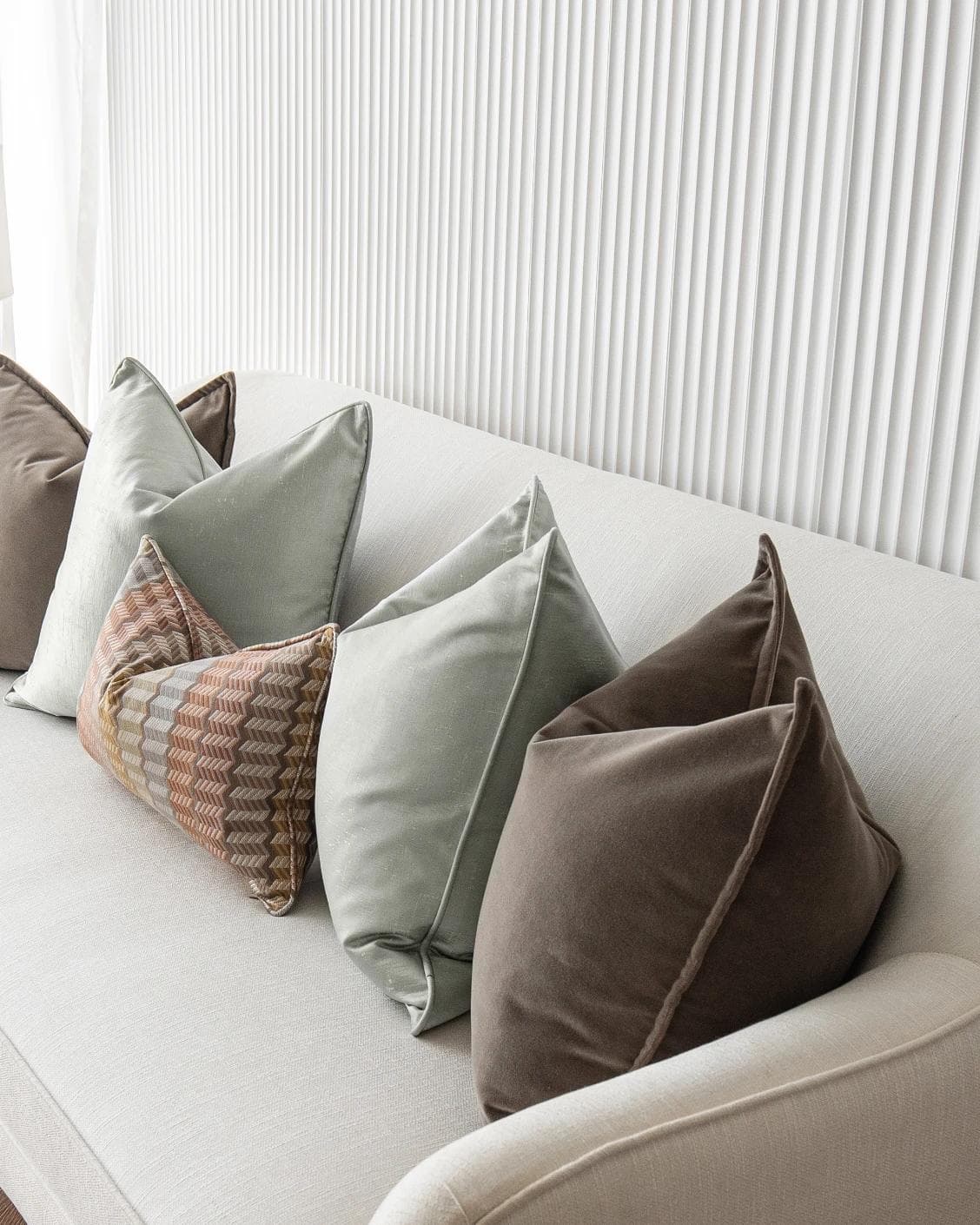 Eliazar Bundle cushion in brown, orange, silver and green, shown in a product right view as image 7