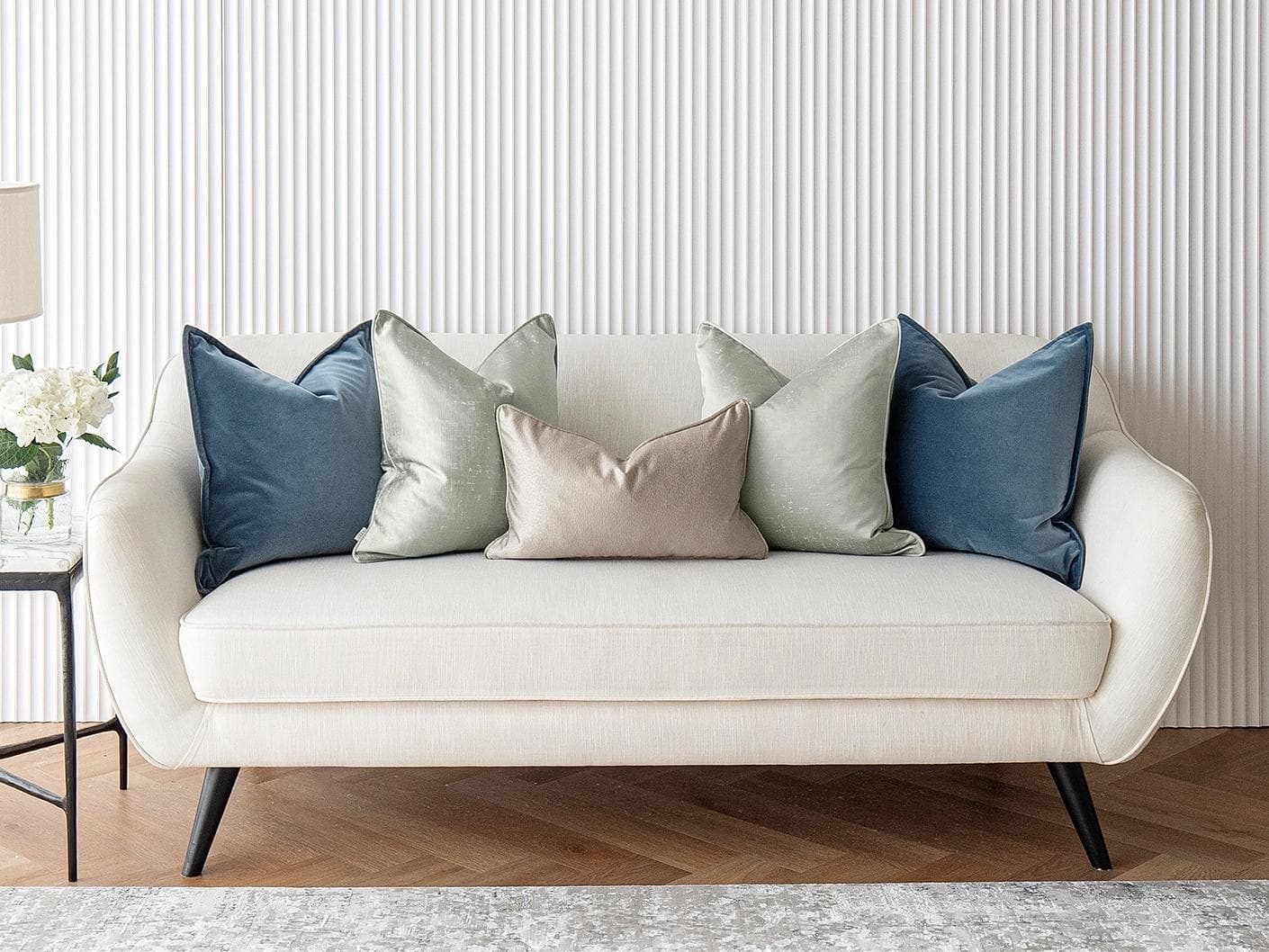 Johnston Bundle cushion in gold, blue, beige, green and silver, shown in a lifestyle front view as image 2