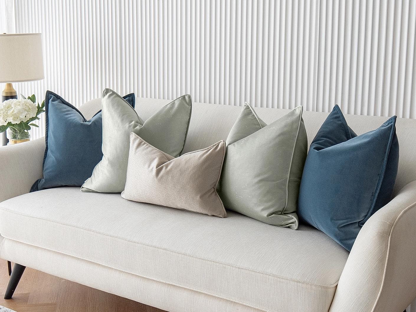 Johnston Bundle cushion in gold, blue, beige, green and silver, shown in a lifestyle right view as image 4