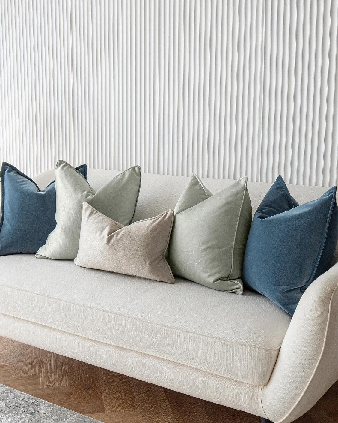 Johnston Bundle cushion in gold, blue, beige, green and silver, shown in a lifestyle right view as image 4