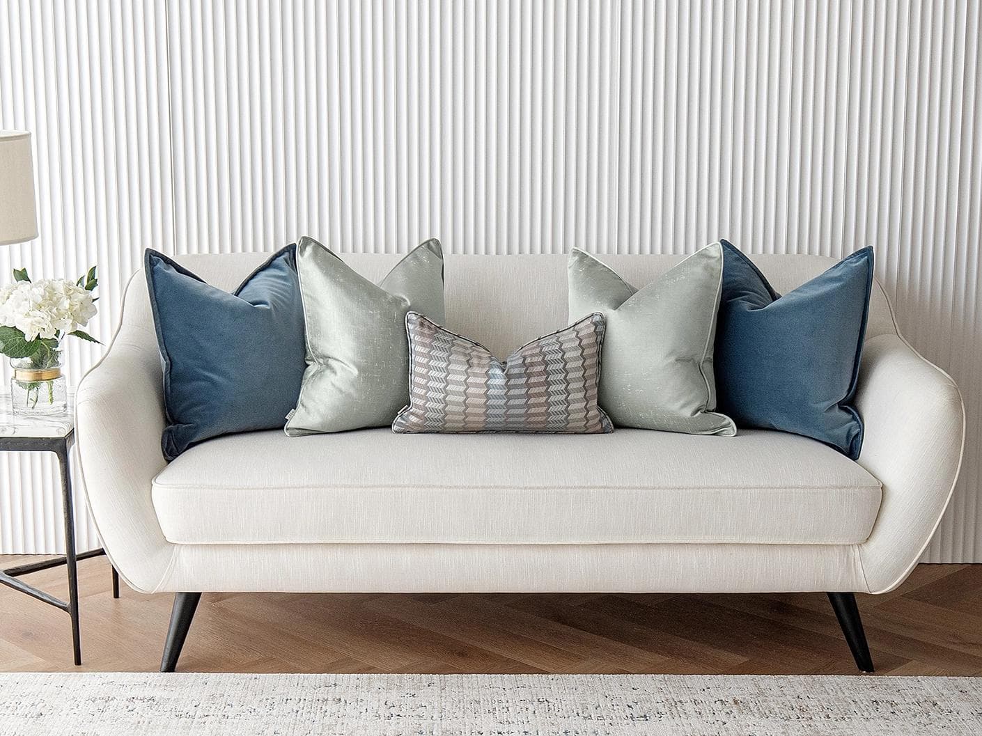 Dionisia Bundle cushion in silver, blue and green, shown in a lifestyle front view as image 4