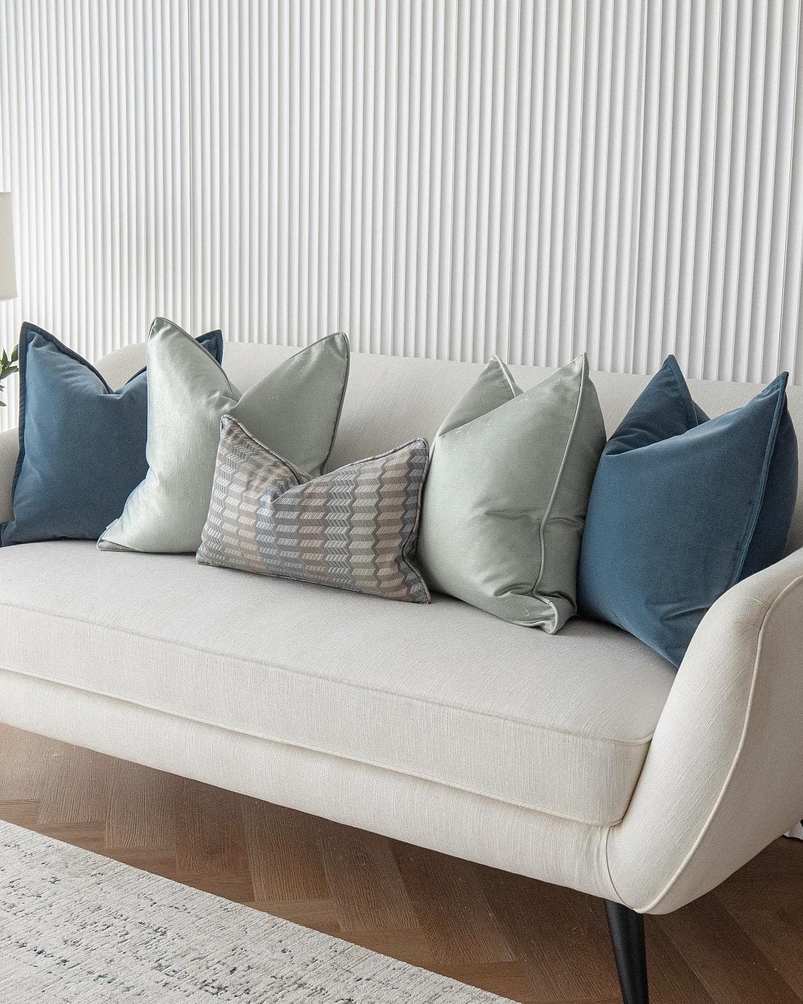Dionisia Bundle cushion in silver, blue and green, shown in a lifestyle right view as image 2