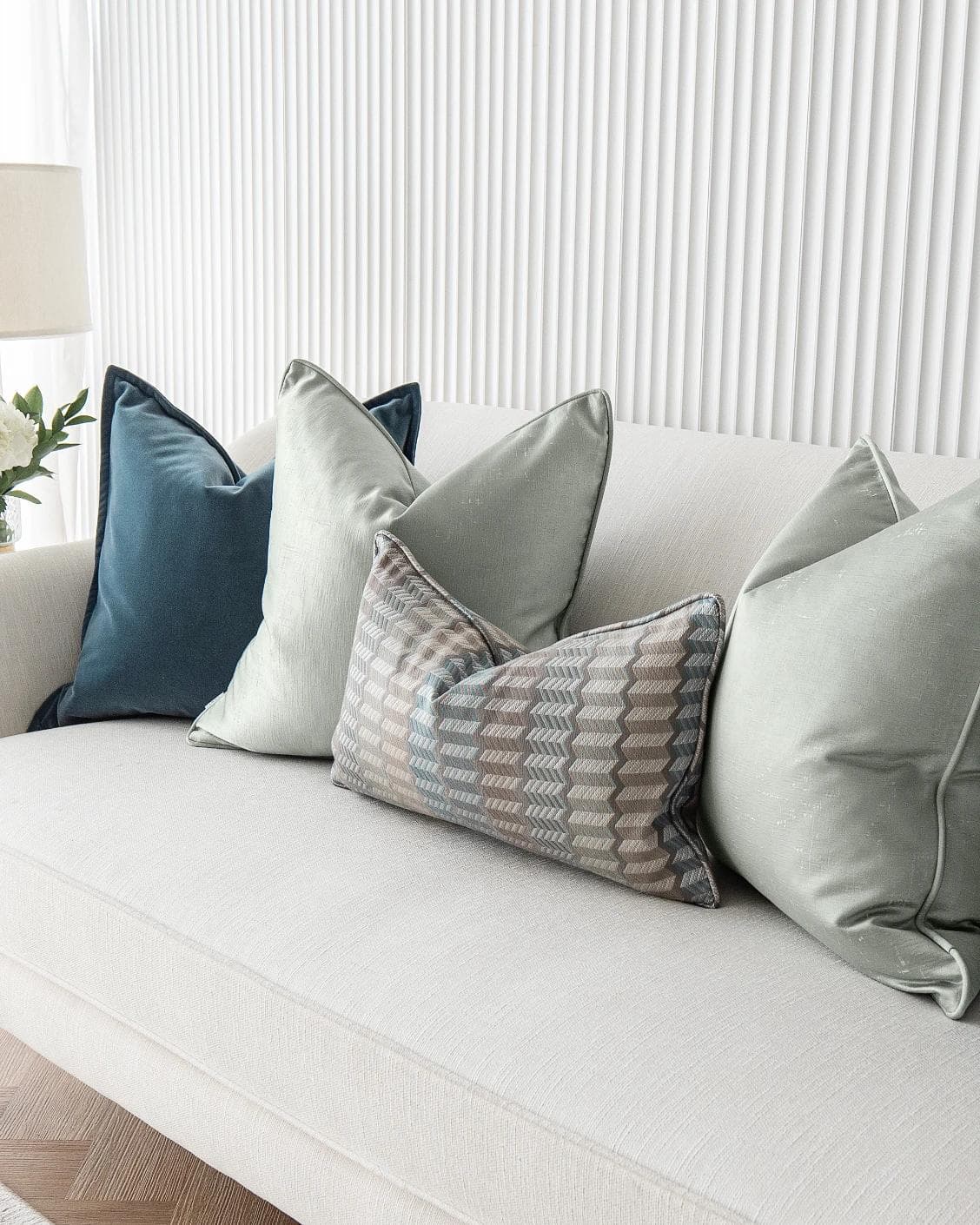 Dionisia Bundle cushion in silver, blue and green, shown in a lifestyle right view as image 5