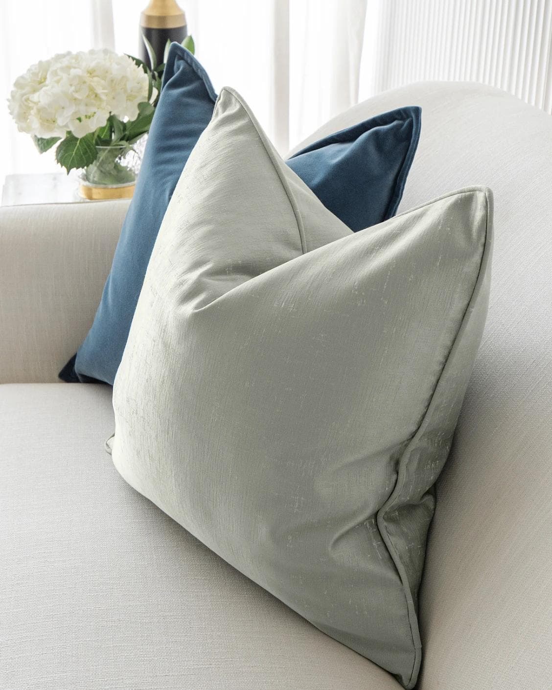 Dionisia Bundle cushion in silver, blue and green, shown in a lifestyle right view as image 6