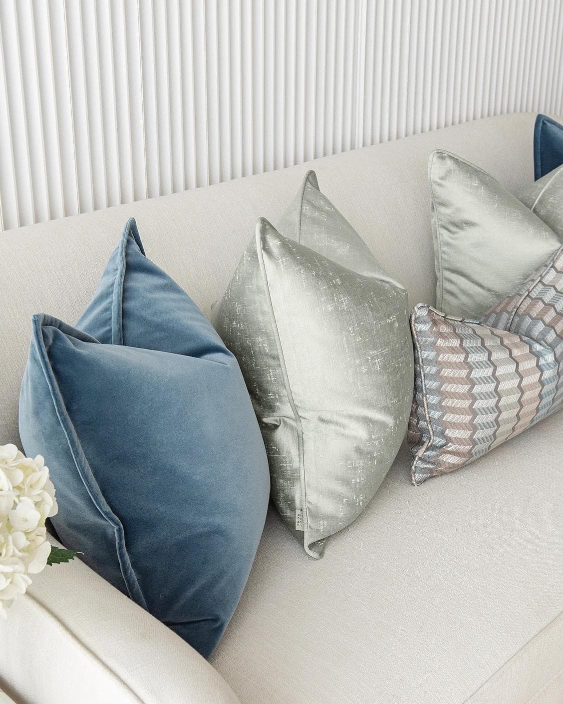 Dionisia Bundle cushion in silver, blue and green, shown in a lifestyle top view as image 7